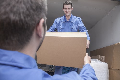 Furniture and boxes being loaded into a moving truck in Hatch End