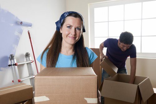 Professional movers loading household items into a removal van