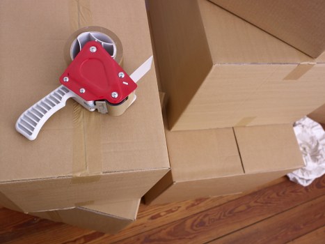 Packed moving boxes and furniture ready for a local home relocation